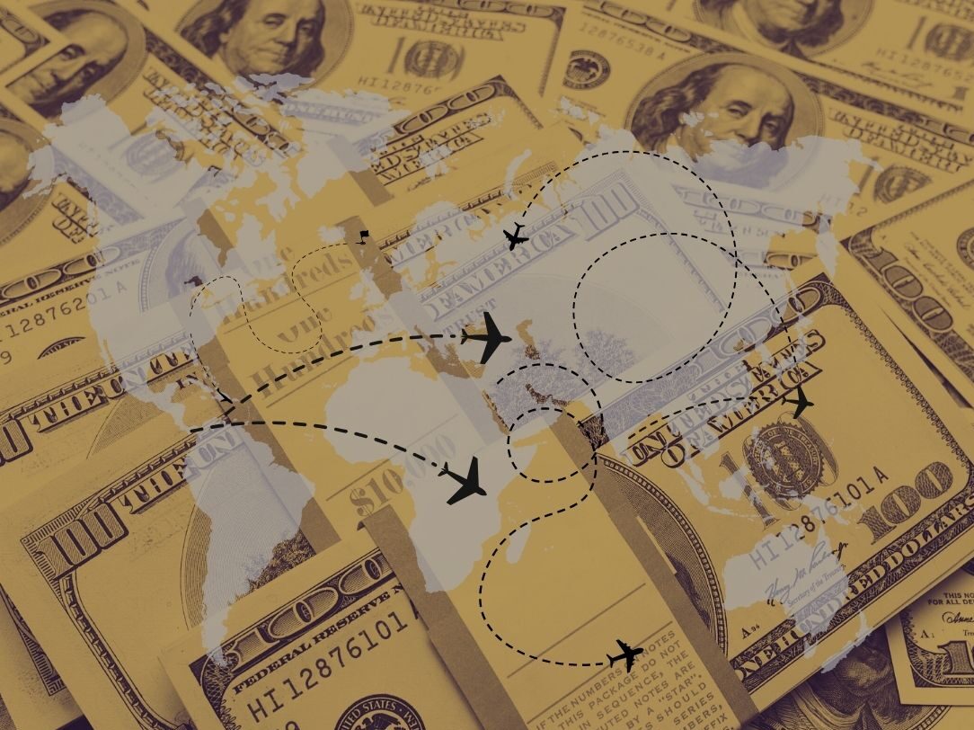 money behind a world map with plane routes